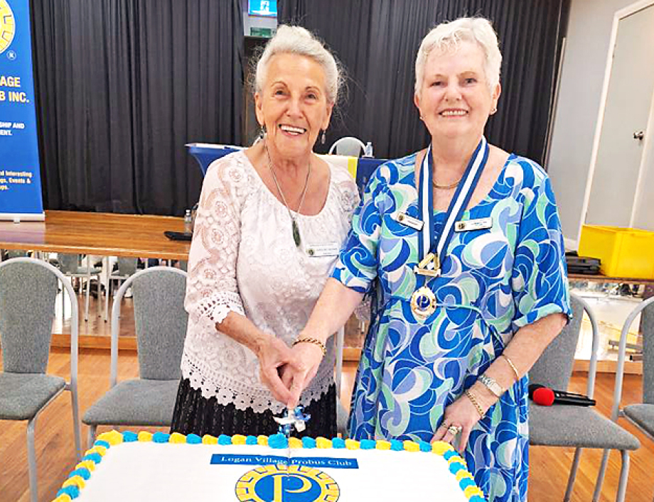 Caroline Nelson PSPL cutting birthday cake with President Cherylyn